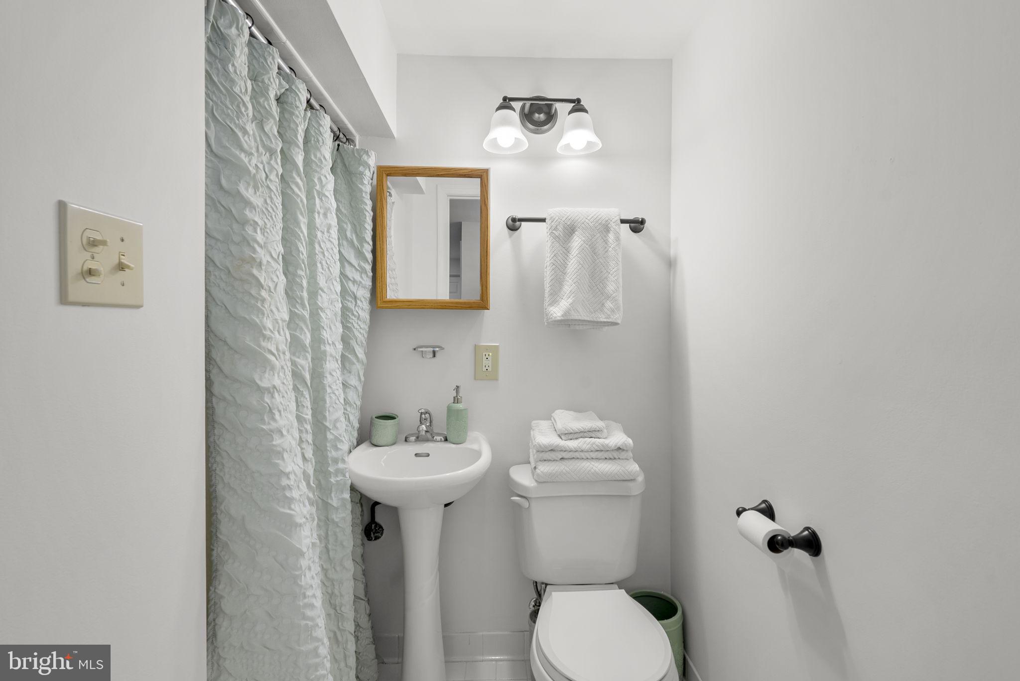 1210 Ashton Road Ashton, MD 20861 - Photo 51 of 71 a bathroom with a toilet sink and mirror