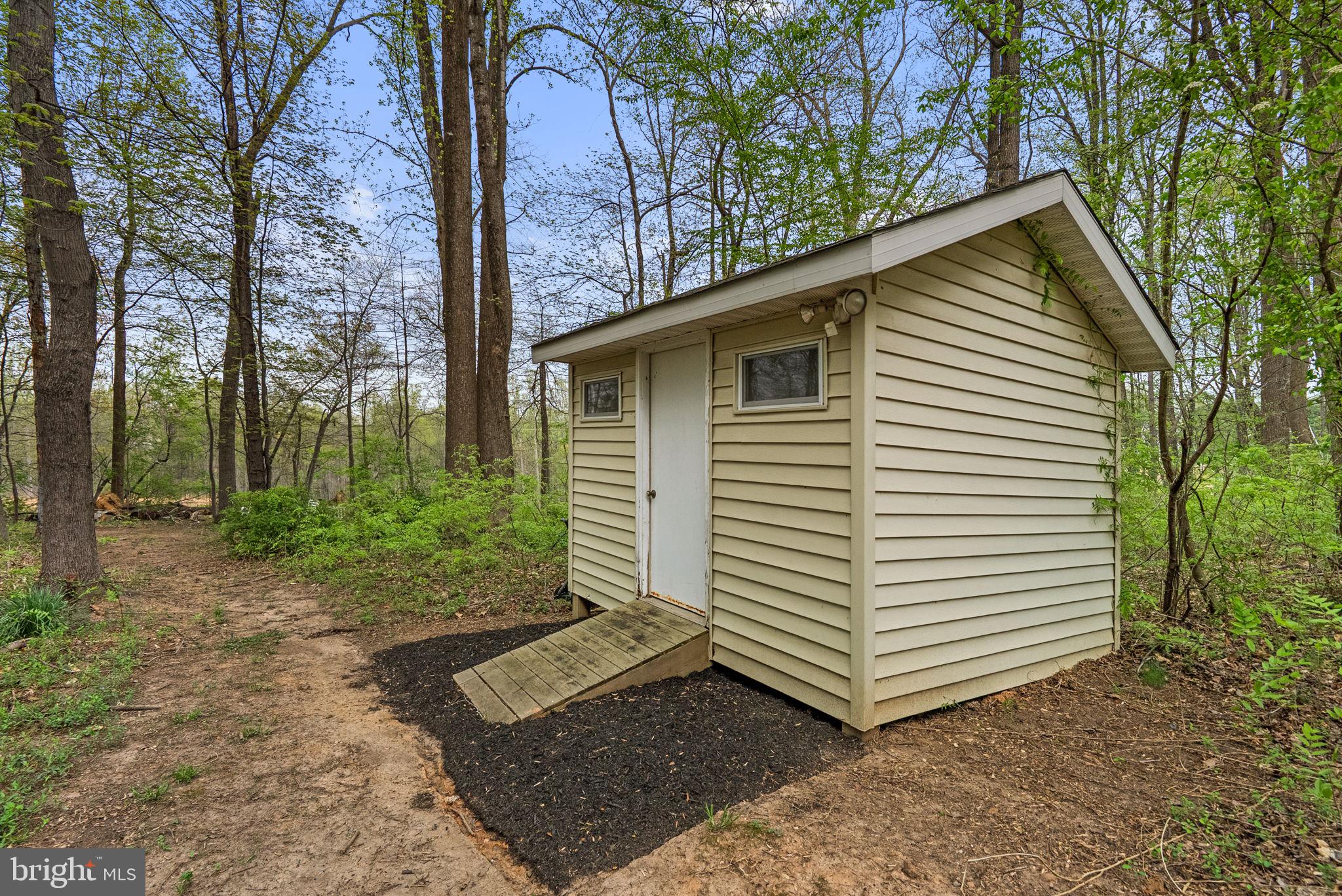 1210 Ashton Road Ashton, MD 20861 - Photo 56 of 71 a view of a small house with a yard and tree
