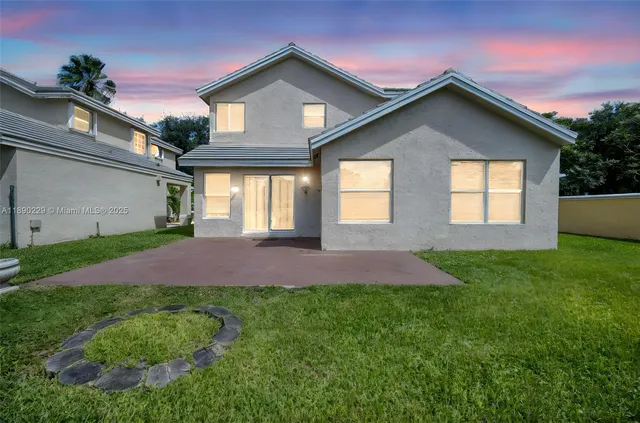 a kitchen with stainless steel appliances granite countertop a refrigerator and a stove