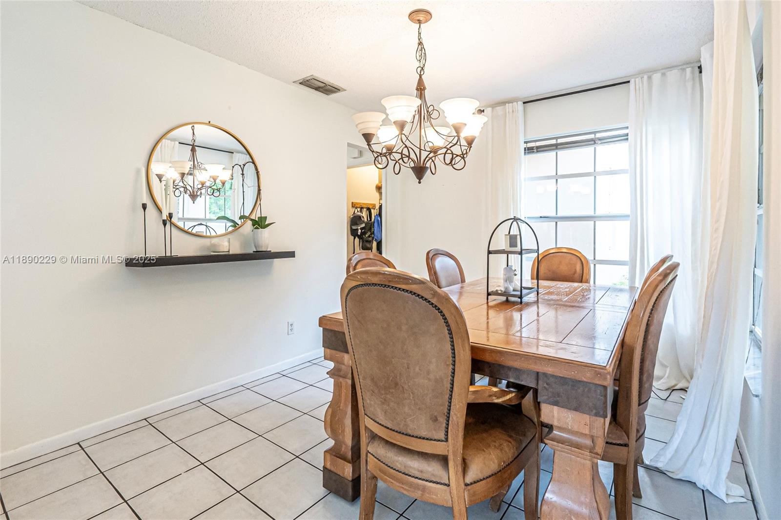 2913 Myrtle Oak Circle Davie, FL 33328 - Photo 22 of 35 a view of a dining room with furniture and chandelier