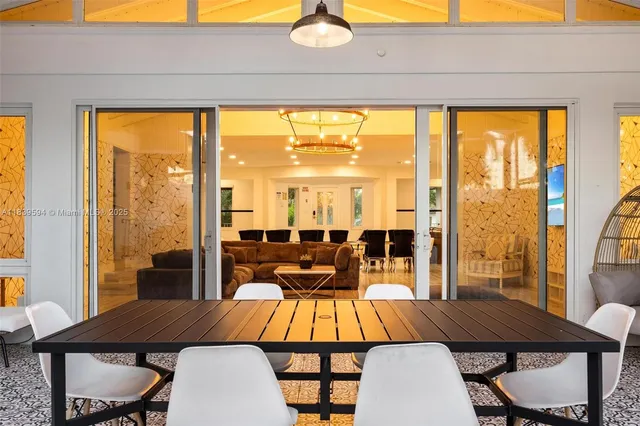 a view of a house with swimming pool and sitting area