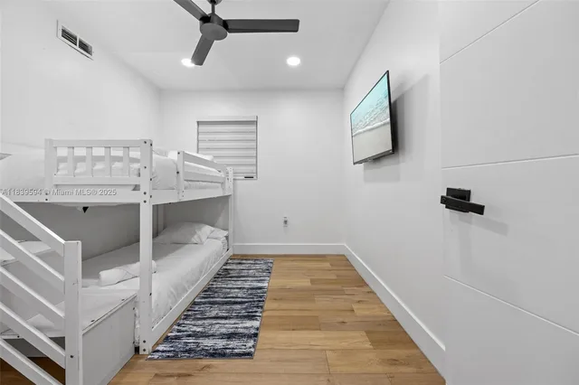 a room with furniture pool table and wooden floor