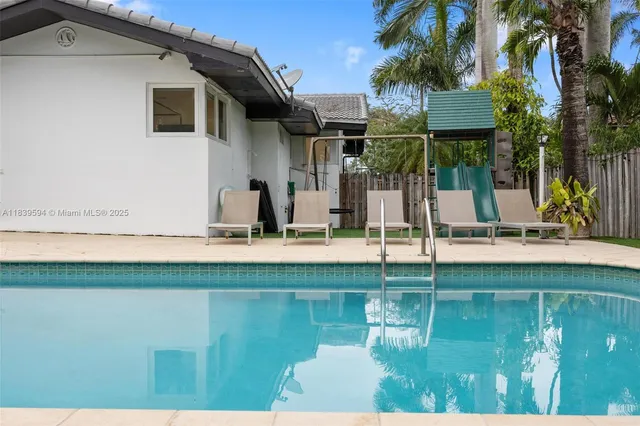 a utility room with wooden floor and cabinets