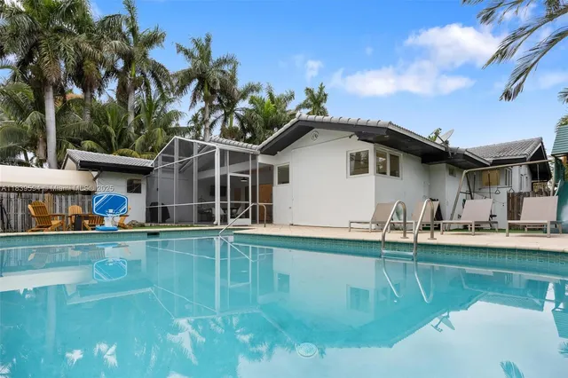 a living room with furniture a chandelier and a chandelier