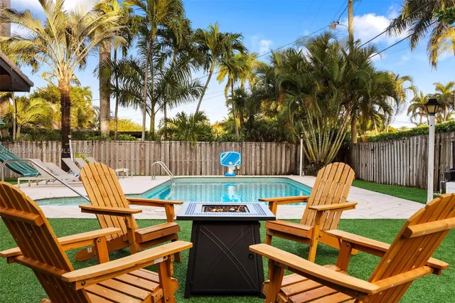 a view of a house with swimming pool and sitting area