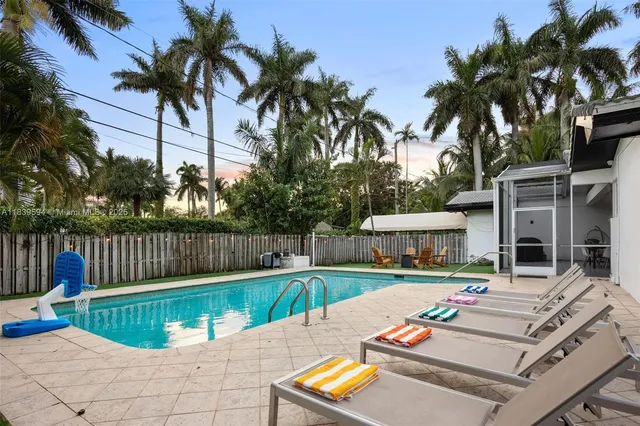 a view of a house with backyard and sitting area