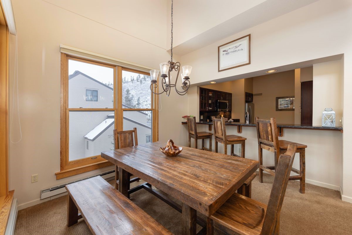 240 Tennis Club Road, Unit 1664 Keystone, CO 80435 - Photo 6 of 26 Carpeted dining room featuring a notable chandelier and baseboard heating