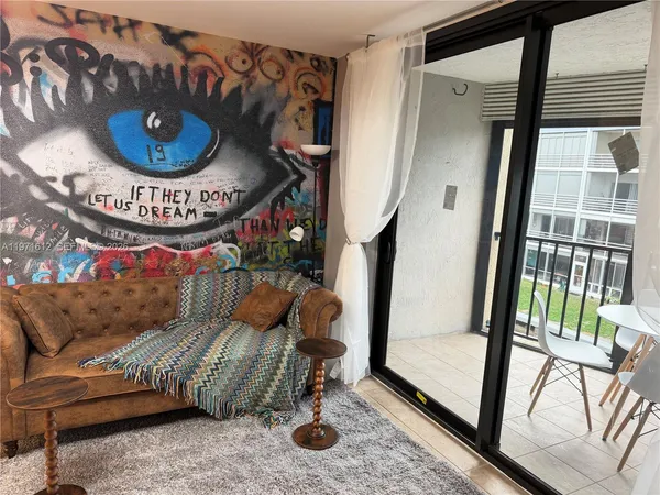 a living room with furniture and a large window