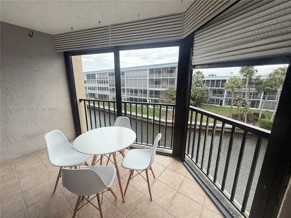 a view of a room with a table and chairs