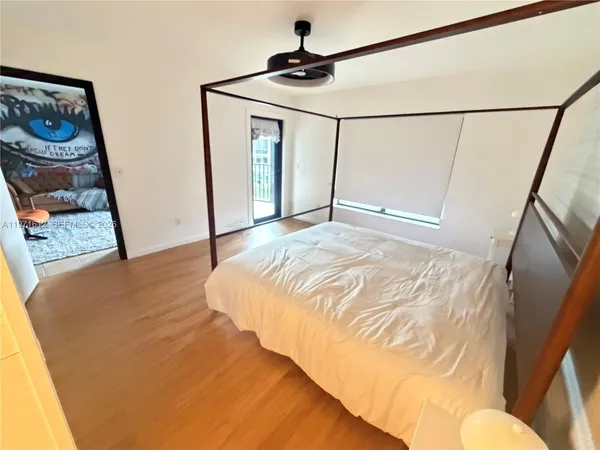 a spacious bathroom with a granite countertop sink a mirror and a shower