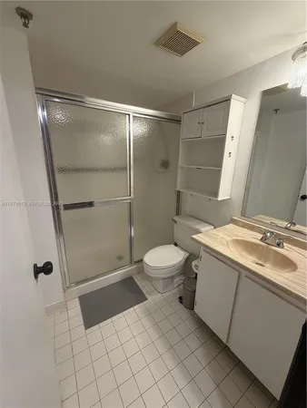 a bedroom with a bed and a mirror
