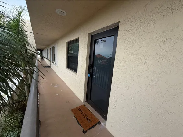 a view of building with cars parked