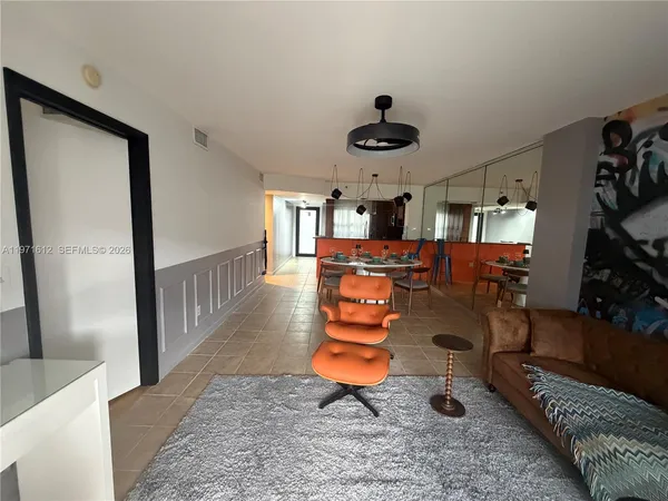 a living room with furniture and a chandelier