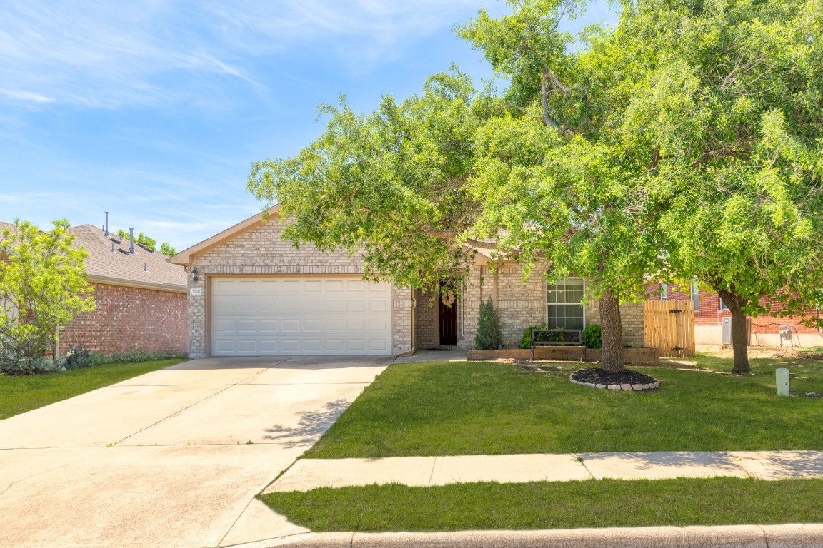 Charming all-brick home nestled behind a majestic mature oak tree, offering natural shade and timeless curb appeal. Perfect blend of style and natural beauty.