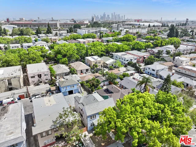 an aerial view of residential house with lots of green space