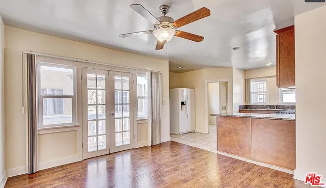 a view of a kitchen with stainless steel appliances granite countertop a refrigerator and a stove