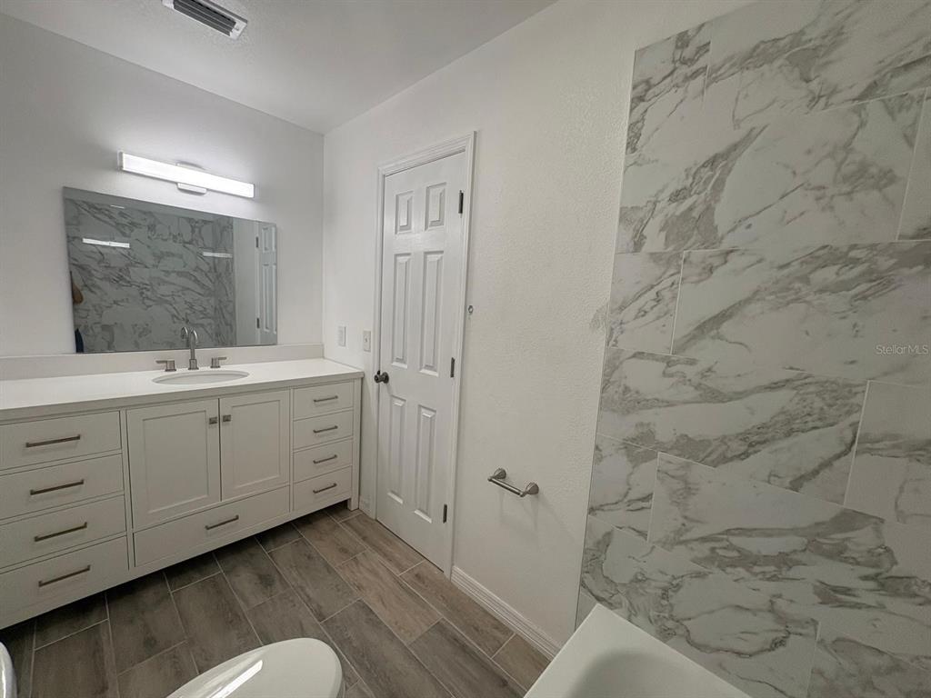 4033 Henley Road, Unit 1707 Orlando, FL 32839 - Photo 41 of 66 a spacious bathroom with a double vanity sink a mirror and a shower