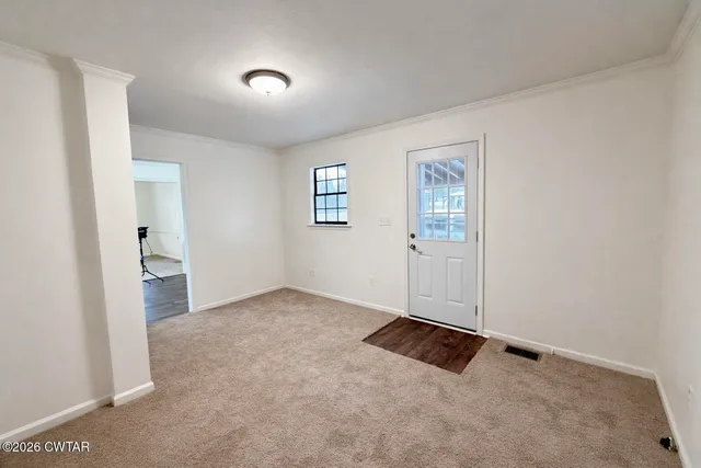 an empty room with entrance and windows