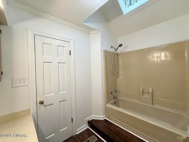 a bathroom with a tub and shower