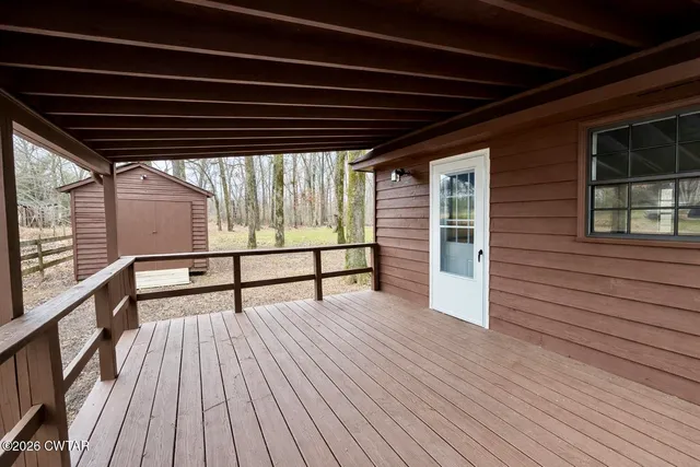 a view of porch with wooden floor and stairs