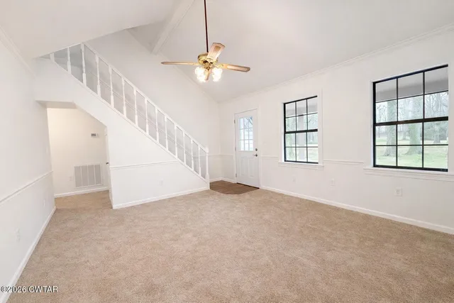 a view of an empty room with a window