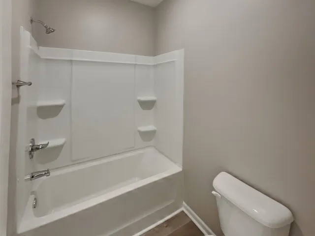 a bathroom with a toilet and bathtub