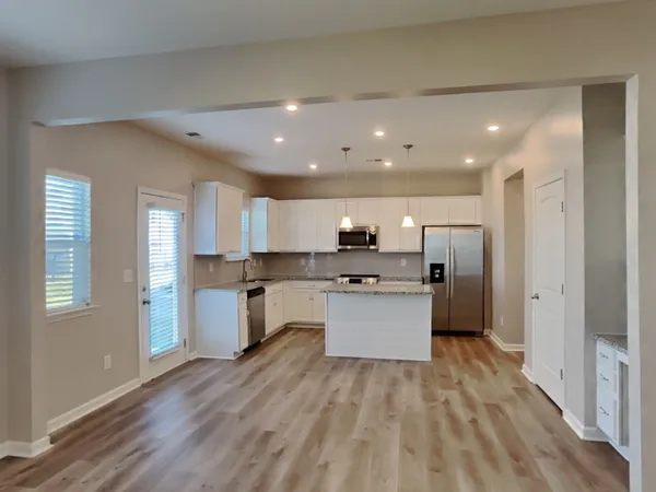a kitchen with kitchen island sink and refrigerator