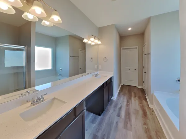 a spacious bathroom with a double vanity sink and a mirror