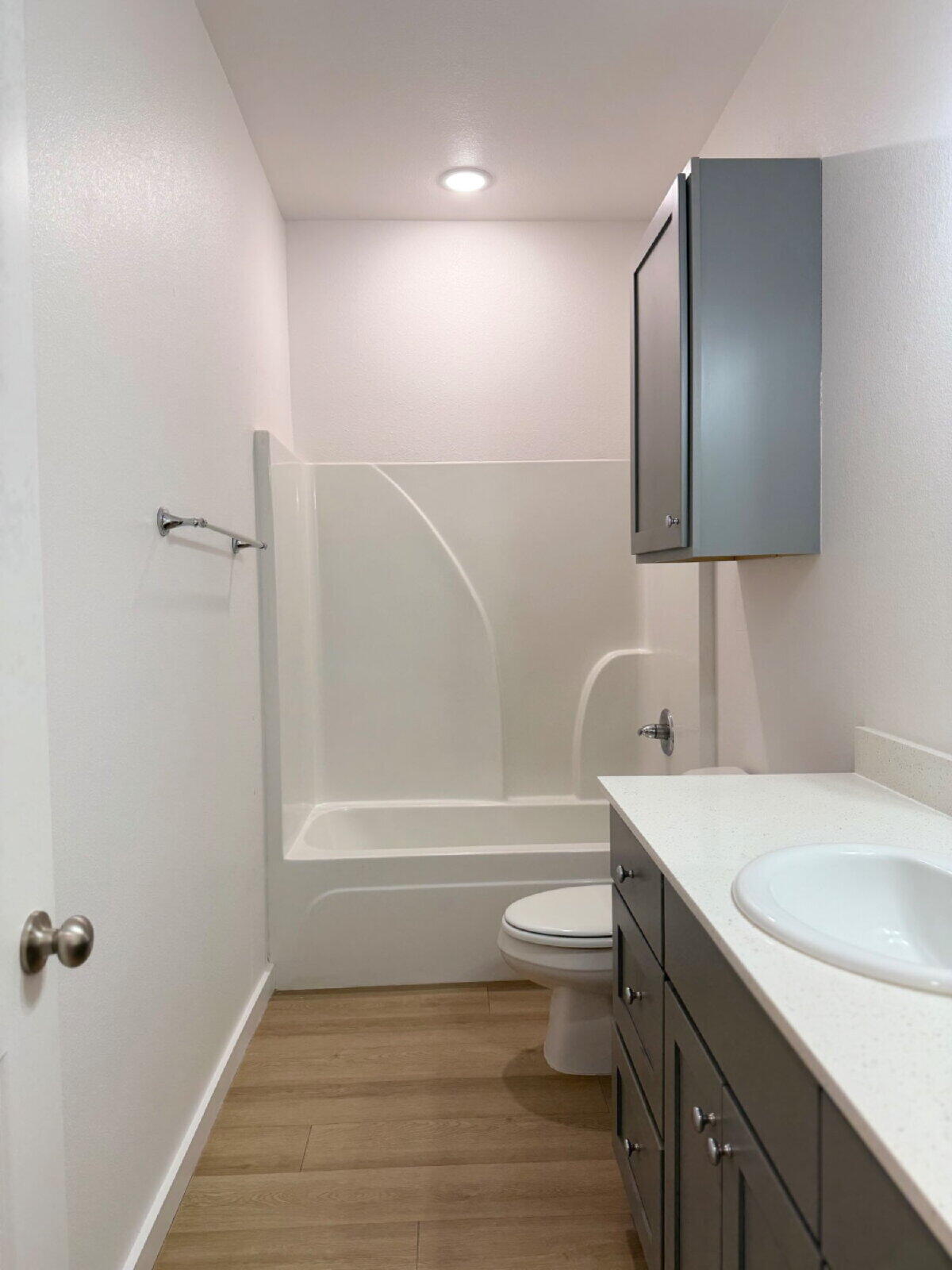 5703 Kemper Street, Unit 2 Lubbock, TX 79416 - Photo 13 of 26 a bathroom with a sink toilet vanity and shower