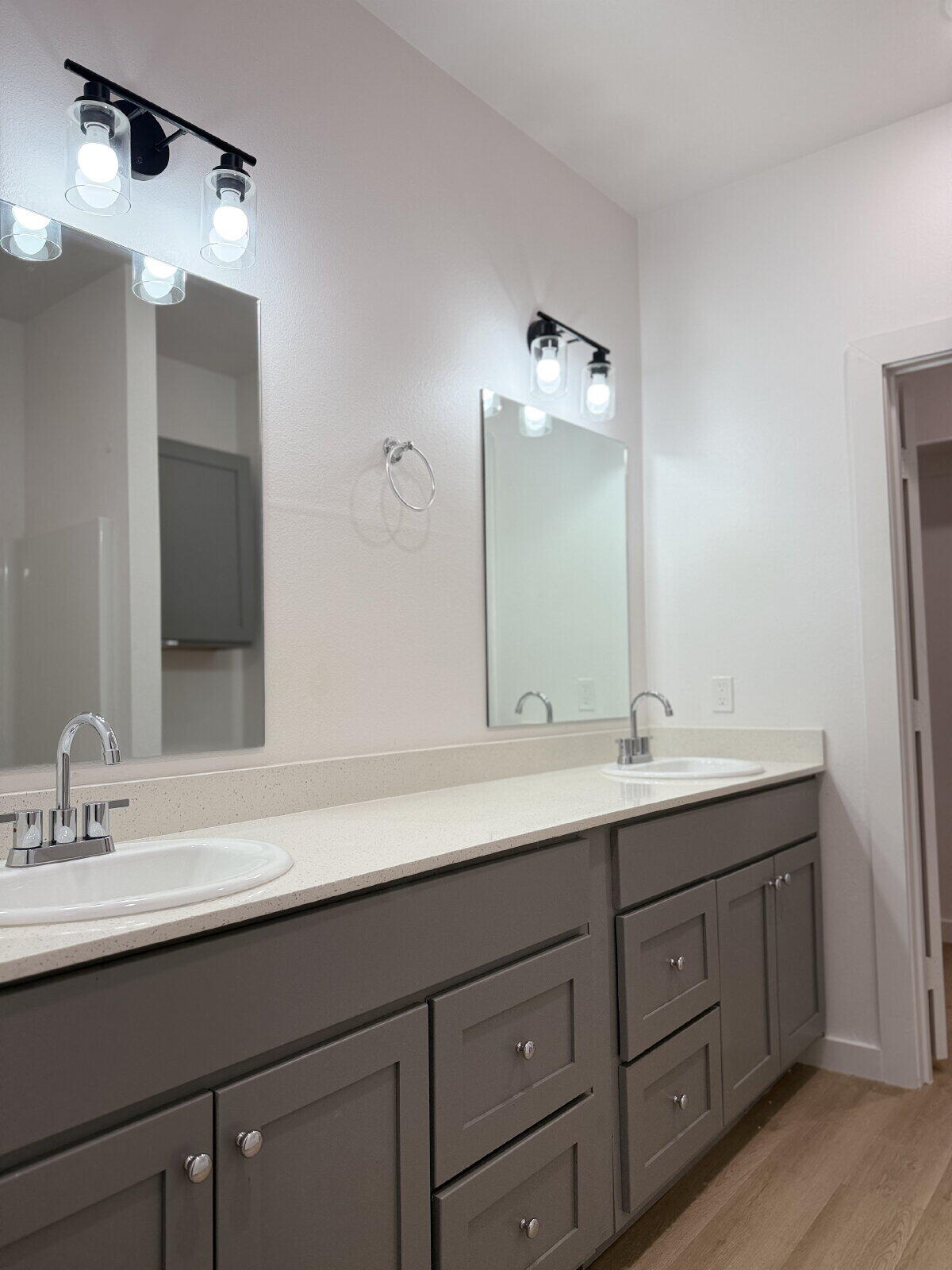 5703 Kemper Street, Unit 2 Lubbock, TX 79416 - Photo 21 of 26 a bathroom with a double vanity sink and mirror