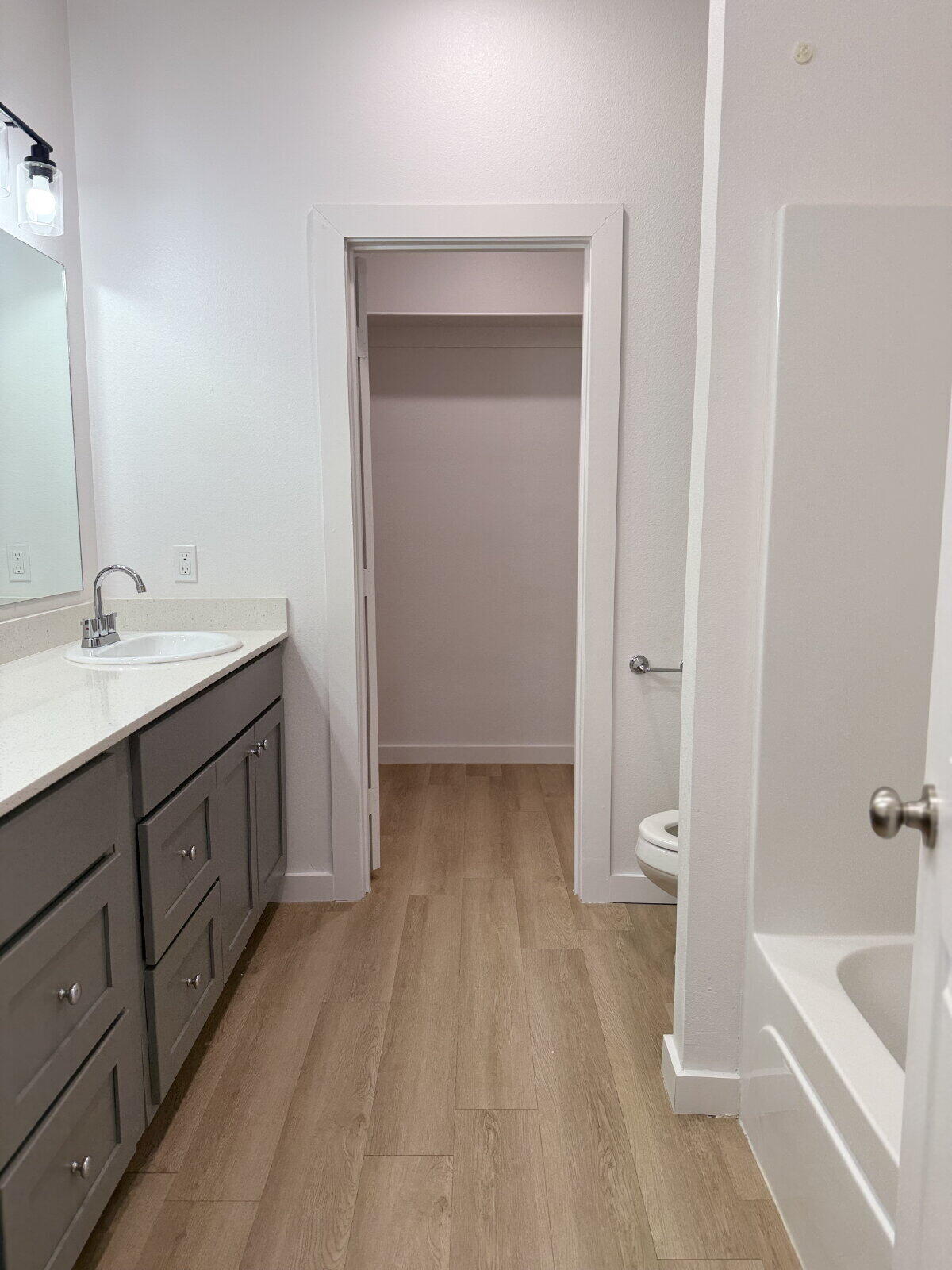 5703 Kemper Street, Unit 2 Lubbock, TX 79416 - Photo 22 of 26 a spacious bathroom with a tub sink and mirror
