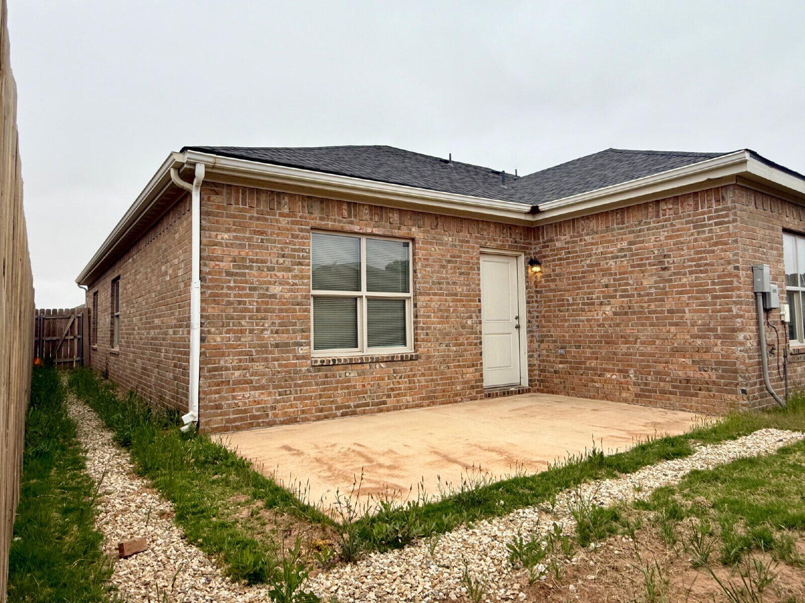 5703 Kemper Street, Unit 2 Lubbock, TX 79416 - Photo 25 of 26 a front view of a house with a yard