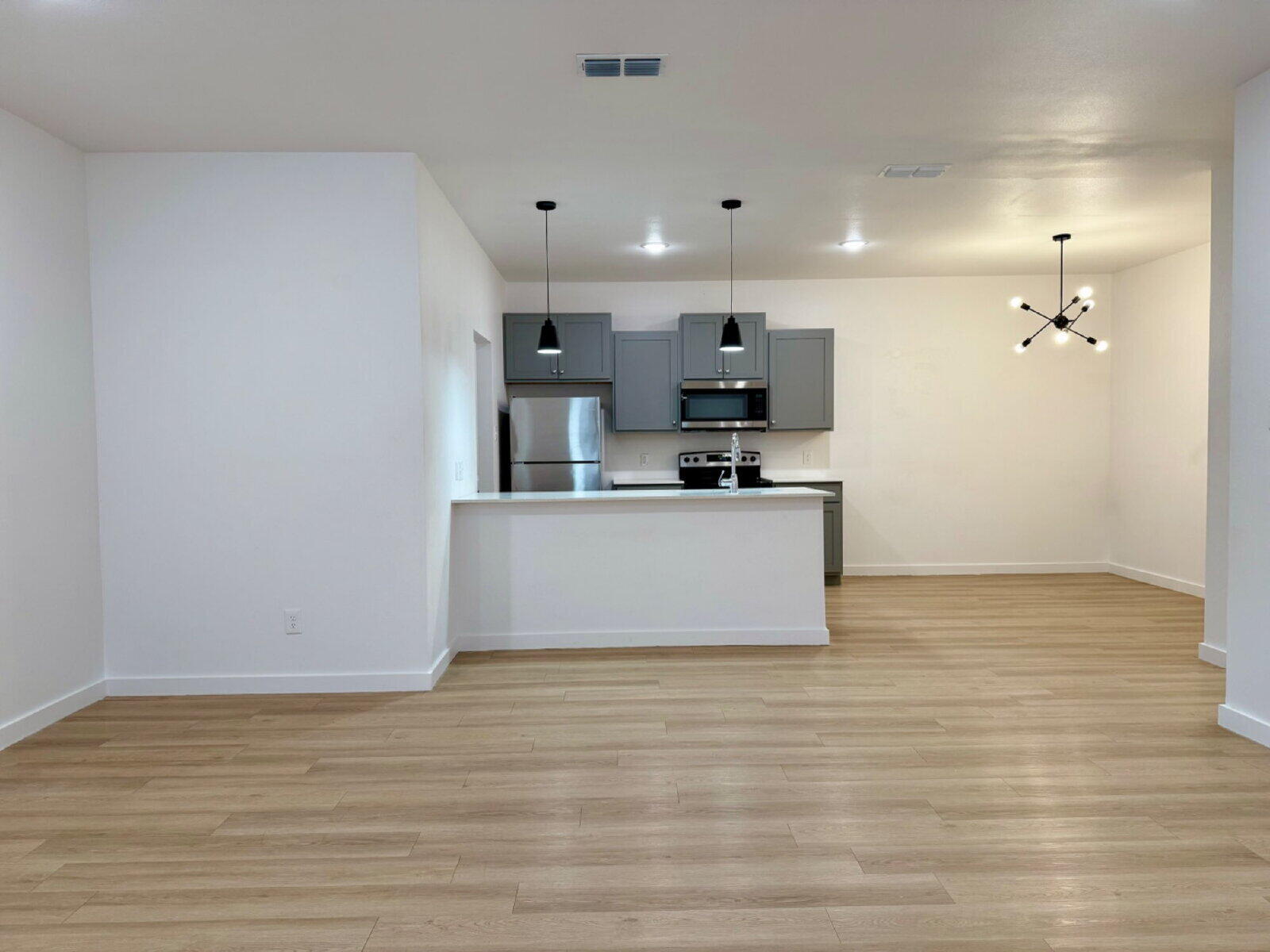 5703 Kemper Street, Unit 2 Lubbock, TX 79416 - Photo 5 of 26 a view of a kitchen with stainless steel appliances a sink and a refrigerator