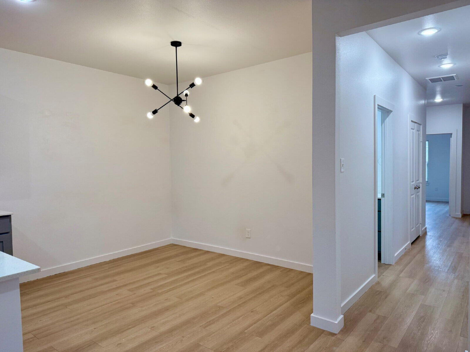 5703 Kemper Street, Unit 2 Lubbock, TX 79416 - Photo 6 of 26 wooden floor in an empty room with a window