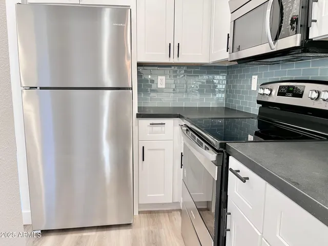a white refrigerator freezer sitting inside of a kitchen