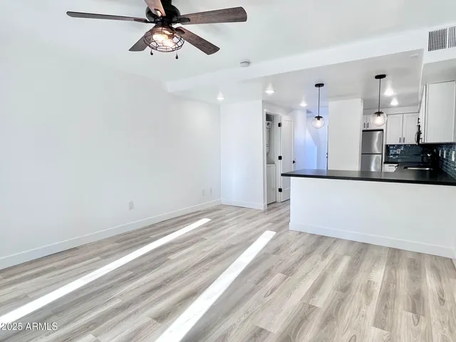 a view of a kitchen with a sink and cabinets