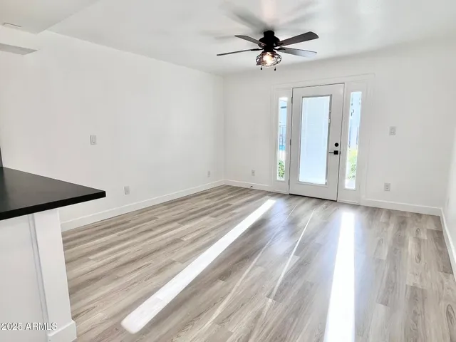 wooden floor in an empty room with a window