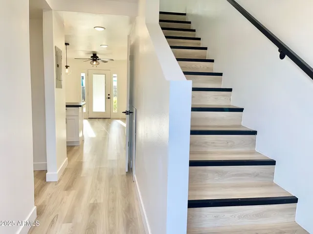 a view of entryway and hall with wooden floor