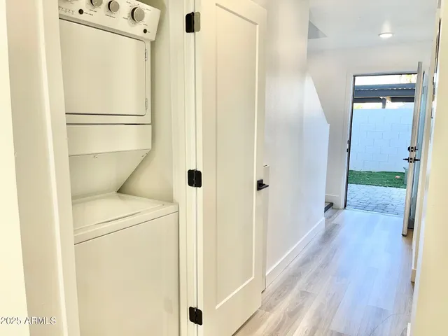 a view of walk in closet with wooden floor