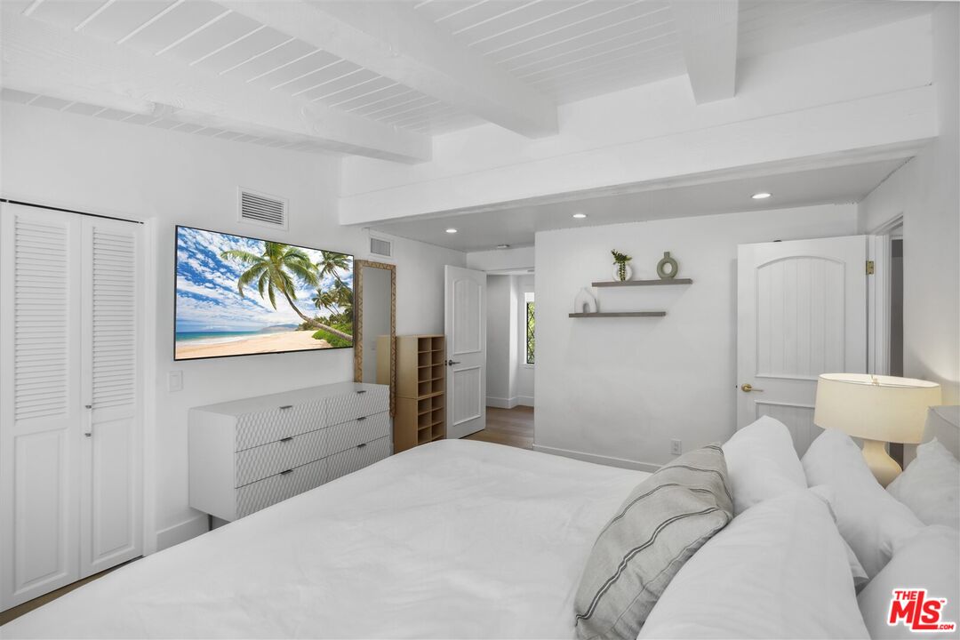 31500 Victoria Point Road Malibu, CA 90265 - Photo 42 of 53 a bedroom with a bed and a flat screen tv