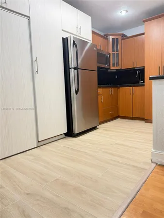 a view of a kitchen with a refrigerator