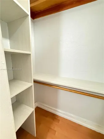 a close view of closet with wooden floor