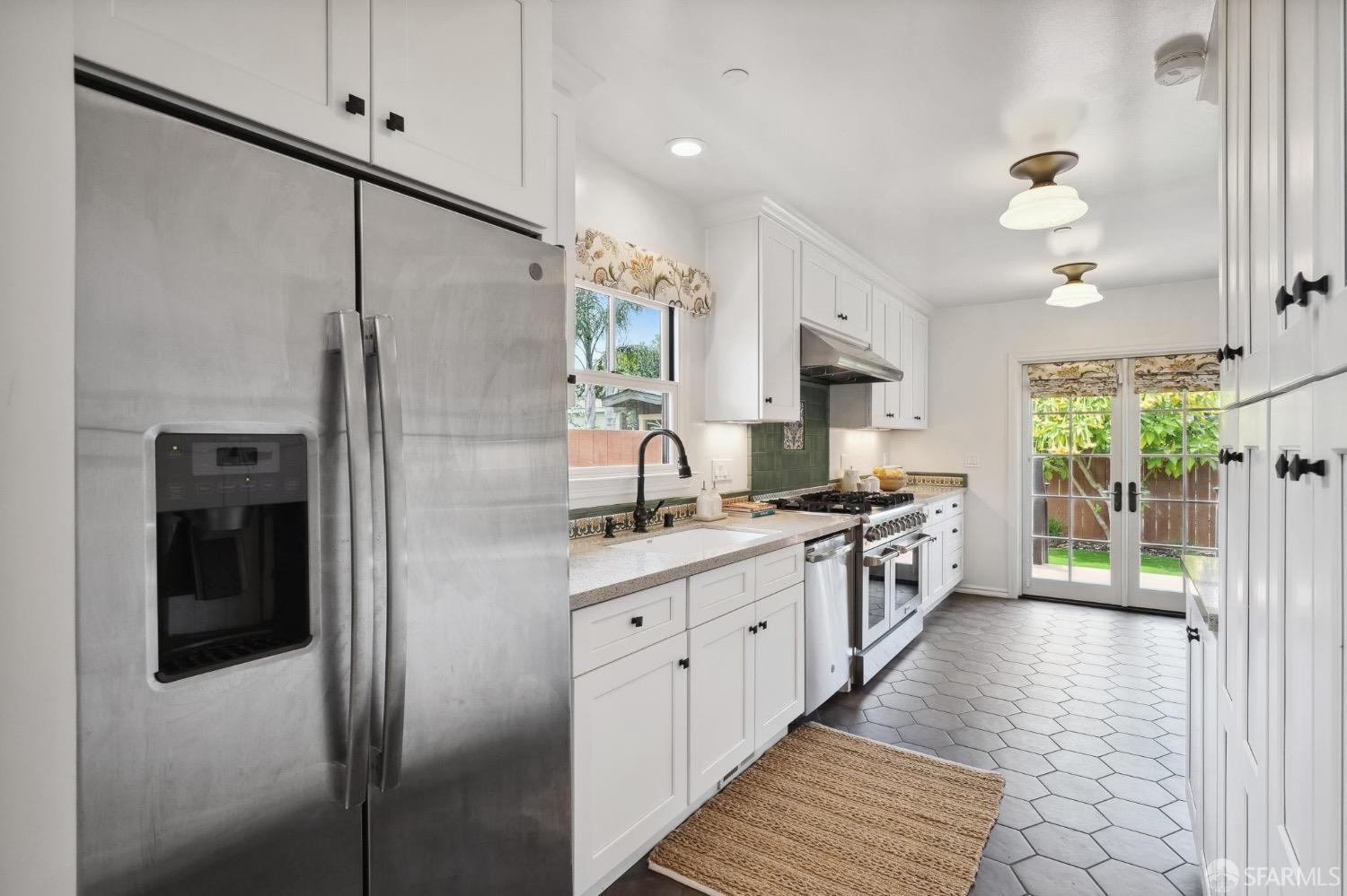 508 Talbot Avenue Albany, CA 94706 - Photo 14 of 66 a kitchen with stainless steel appliances granite countertop a refrigerator a sink dishwasher a oven with white cabinets and wooden floor
