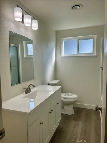 a bathroom with a sink toilet and a mirror