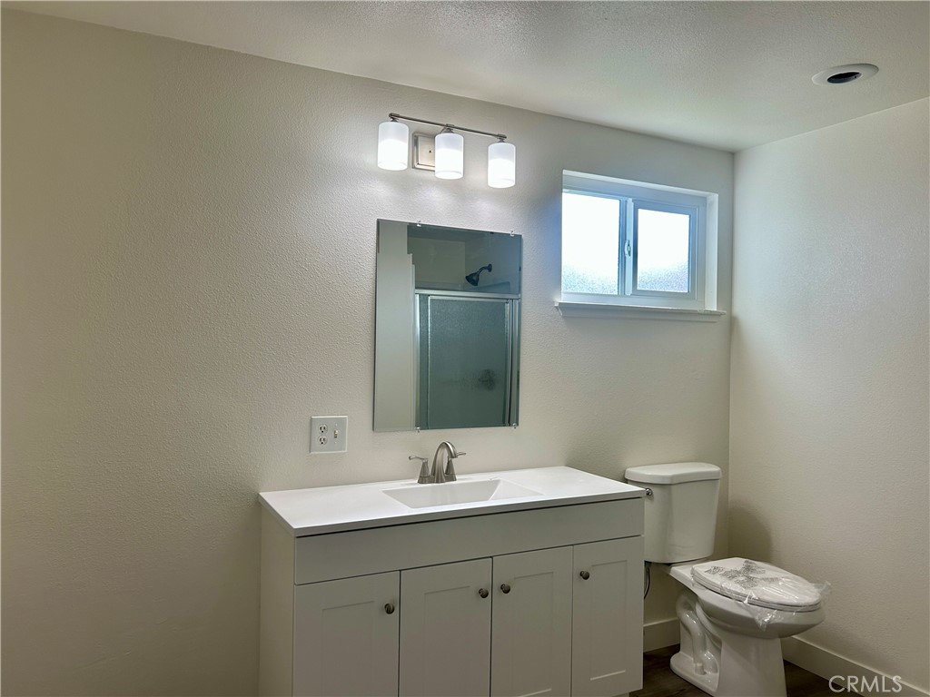 1007 Harrison Court Upland, CA 91786 - Photo 9 of 11 a bathroom with a toilet sink and mirror