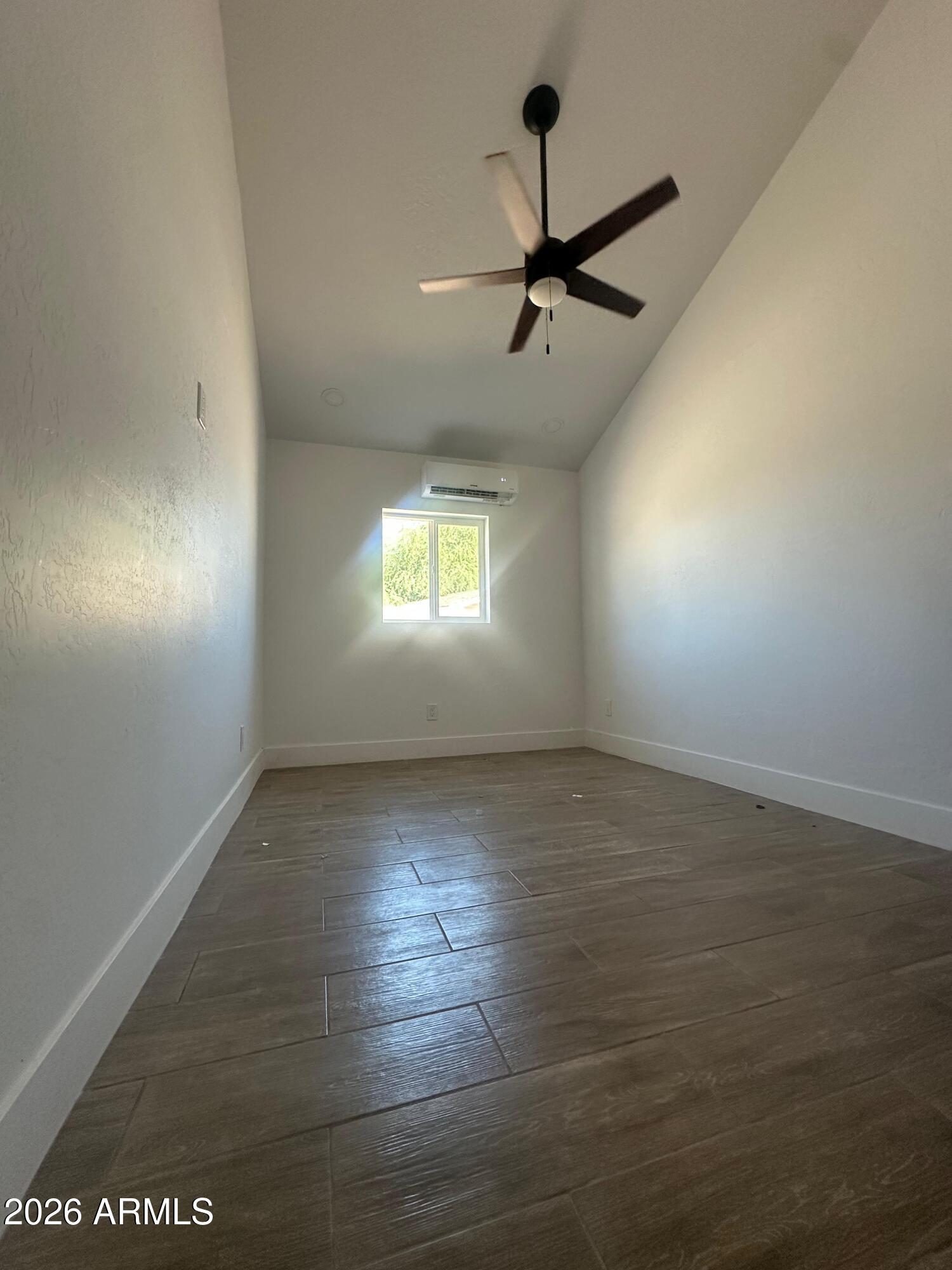 1730 West Thomas Road Phoenix, AZ 85015 - Photo 24 of 38 an empty room with windows and ceiling fan view