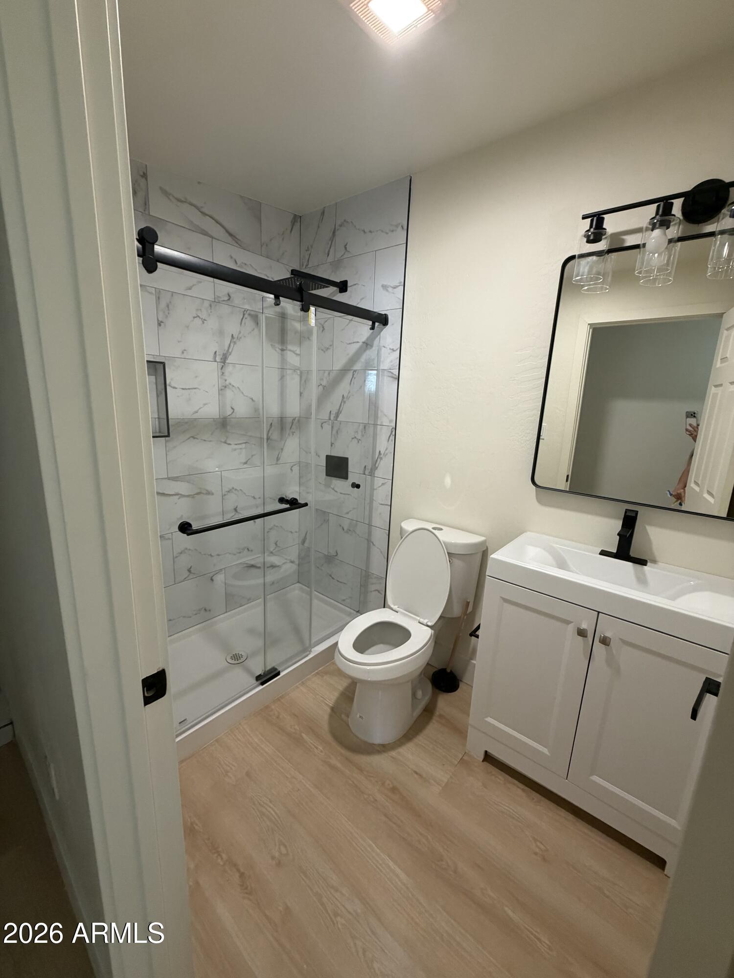 1730 West Thomas Road Phoenix, AZ 85015 - Photo 27 of 38 a bathroom with a toilet a sink and shower