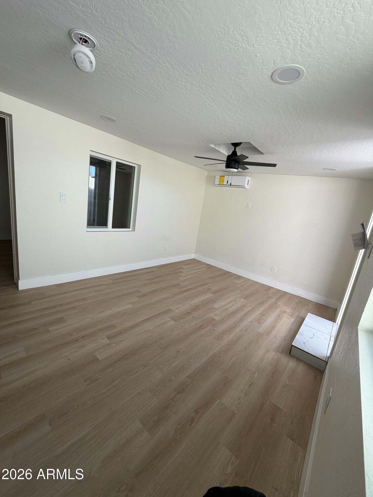 1730 West Thomas Road Phoenix, AZ 85015 - Photo 33 of 38 an empty room with wooden floor and windows