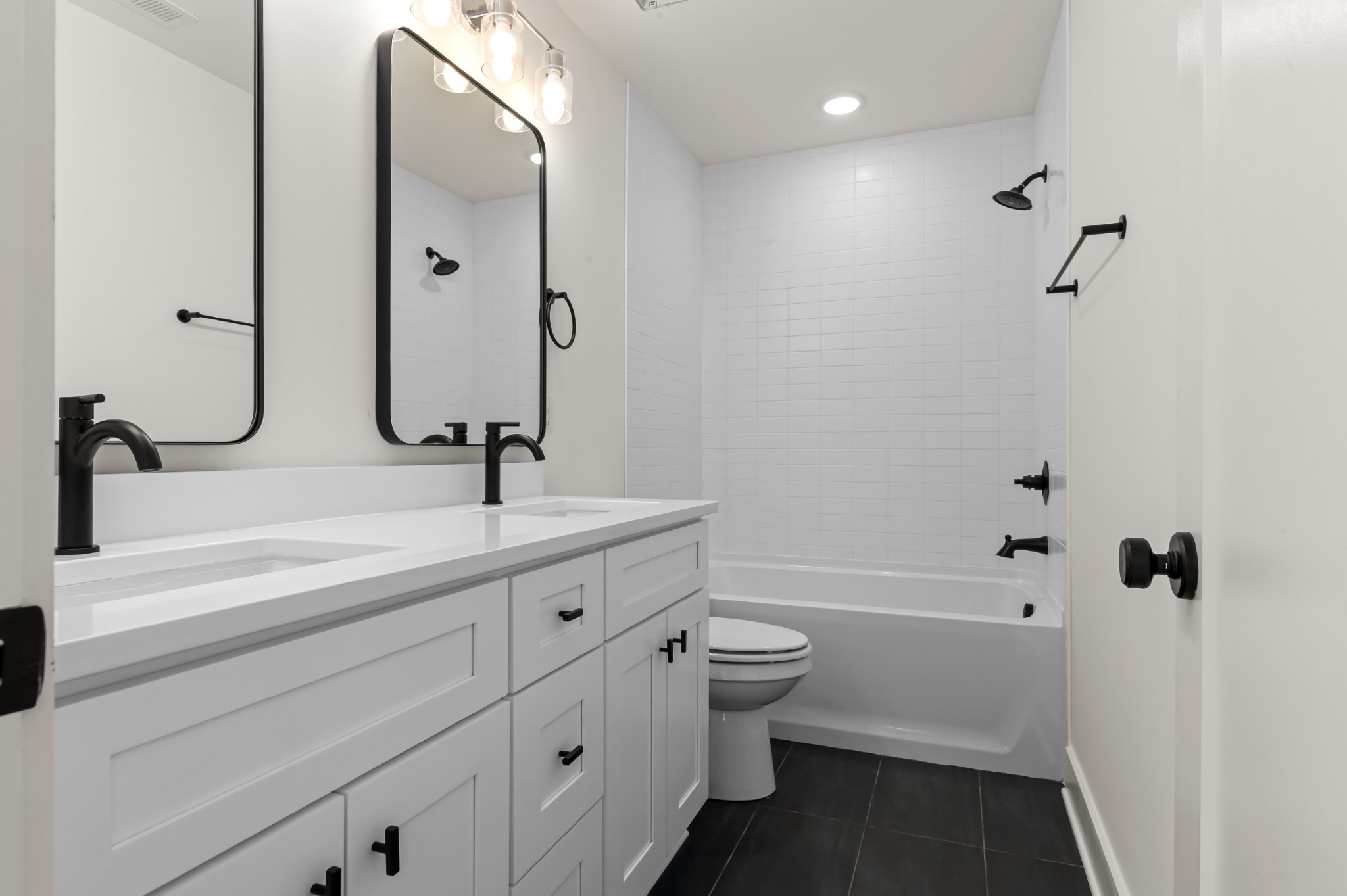 251 Nesbitt Lane Madison, TN 37115 - Photo 12 of 20 a bathroom with a double vanity sink a toilet and shower
