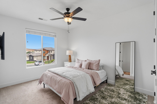 2278 Tawny Ridge Circle St. George, UT 84790 - Photo 40 of 61 Bright bedroom featuring a large window, a ceiling fan with integrated lighting, recessed lighting, and soft carpet flooring